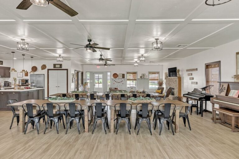 Clubhouse event hall with long tables and seating for gatherings