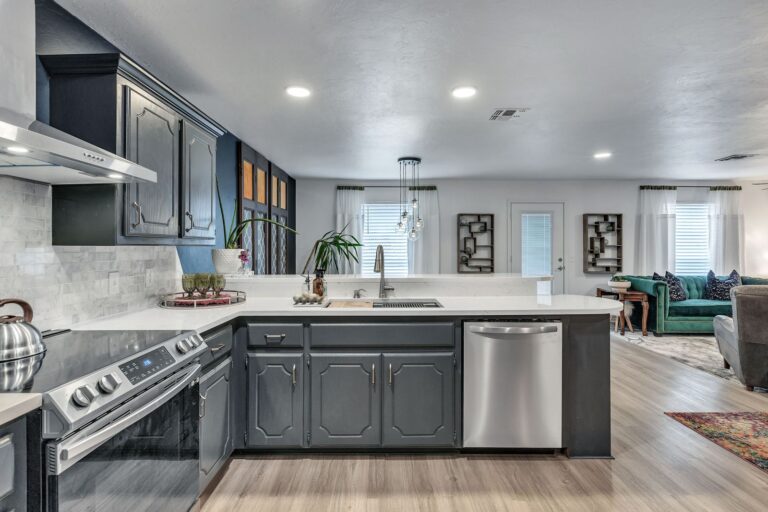 Cottage kitchen with white counters and stainless steel appliances